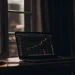 Secure AI investing: Laptop with stock chart.