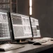 Free algorithmic trading software displayed on monitors.