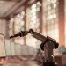 Automated trading system visualized by robotic arm on trading screen.