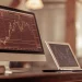 Day trading algorithms analyzing market trends on computer monitors.