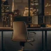 Automated trading program displayed on a monitor overlooking a city at night.