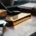 Gold bar, watch, and wallet. Gold ETF investing.