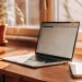 Start automated investing with a laptop, notebook, and pen.