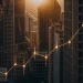 Rising stock market graph over skyscrapers.